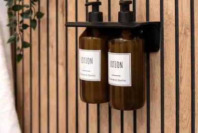 two bottles of wine are hanging on a wall at Bianca Guest House in Rome