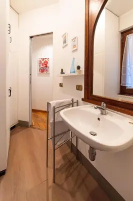 a bathroom with a sink and a mirror at Pantheon Private Apartment in Rome