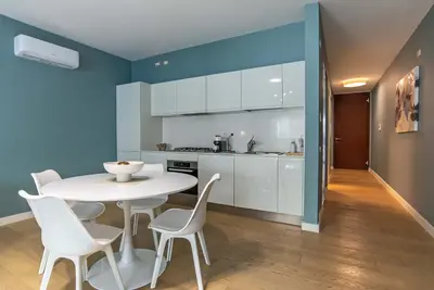 a kitchen and dining room with a white table and chairs at Albertahaus in Rome
