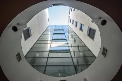 an image of a circular mirror in a building at Albertahaus in Rome