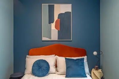 a blue bedroom with a bed with a blue wall at Albertahaus in Rome