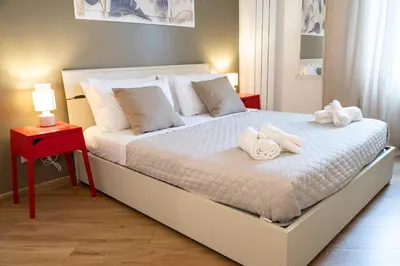 a bedroom with a white bed with towels on it at Licia House - Intero Appartamento - San Giovanni in Rome