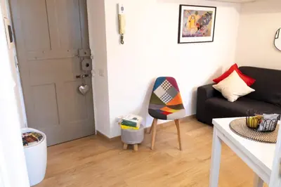 a living room with a black couch and a chair at Licia House - Intero Appartamento - San Giovanni in Rome