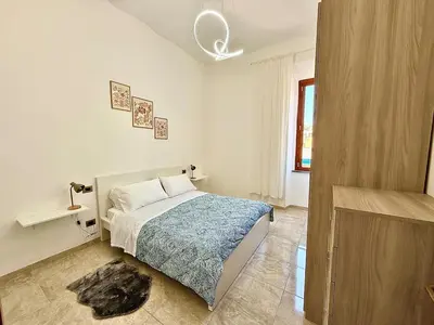 a white bedroom with a bed and a window at SanLo Nest in Rome