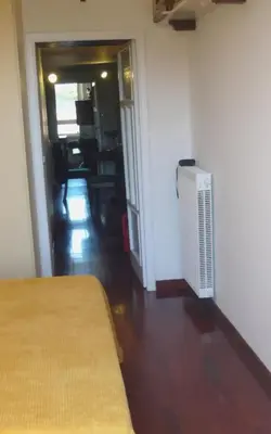 a room with a bed and a hallway with a room with a heater at Laurina 4 - LOCAPPART in Rome