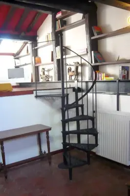 a spiral staircase in a room with a bench at Laurina 4 - LOCAPPART in Rome