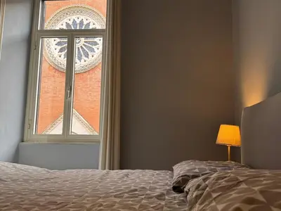 a bedroom with a bed and a window with a building at Casa Amorello - Vaticano in Rome