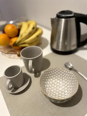 a counter with two cups and a plate of fruit at Casa Amorello - Vaticano in Rome