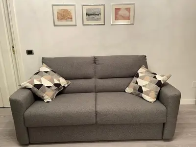 a couch in a living room with two pillows on it at Casa Amorello - Vaticano in Rome