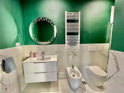 a bathroom with a toilet and a sink and a mirror at Casa Vacanze Jenner in Rome