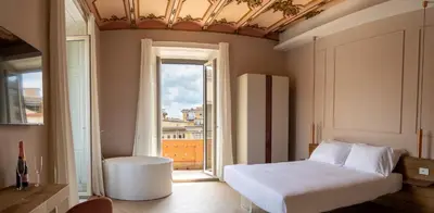 a bedroom with a bed and a large window at Gv Suite Collection - San Pietro Dome in Rome