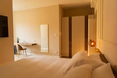 a bedroom with a large white bed with two lights at Gv Suite Collection - San Pietro Dome in Rome
