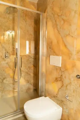 a shower with a glass door with a sink at Gv Suite Collection - San Pietro Dome in Rome