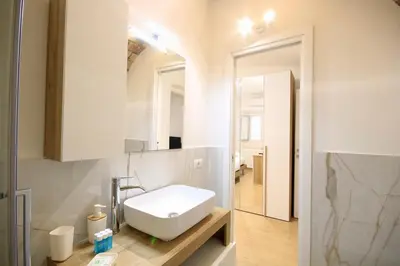 a bathroom with a white sink and a mirror at HC - Pigneto Cozy & Modern Retreat in Rome