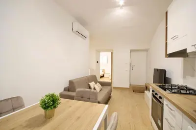 a kitchen and living room with a couch and a table at HC - Pigneto Cozy & Modern Retreat in Rome