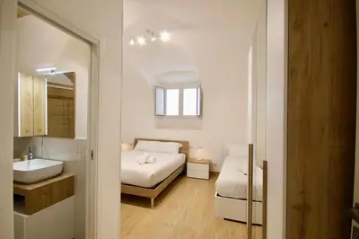 a bedroom with a bed and a sink and a mirror at HC - Pigneto Cozy & Modern Retreat in Rome