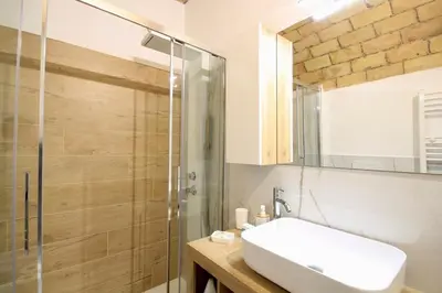 a bathroom with a sink and a shower at HC - Pigneto Cozy & Modern Retreat in Rome