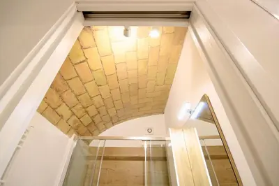 a room with a stone ceiling and a staircase at HC - Pigneto Cozy & Modern Retreat in Rome
