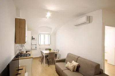 a living room with a couch and a table at HC - Pigneto Cozy & Modern Retreat in Rome
