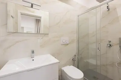 a bathroom with a toilet and a sink and a shower at Suemy Rome B&B in Rome