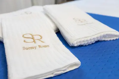 two white towels sitting on top of a blue table at Suemy Rome B&B in Rome