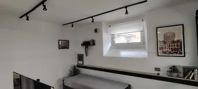a white room with a window and a stair case at Studio Flat Rome Metro Garbatella in Rome