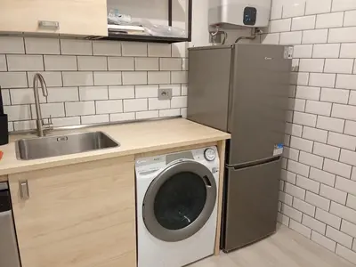 a kitchen with a washing machine and a sink at Studio Flat Rome Metro Garbatella in Rome