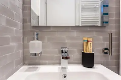 a bathroom sink with a soap dispenser on it at San Giovanni Rooftop in Rome