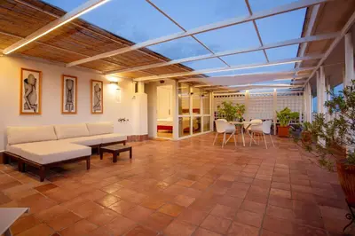 a conservatory with a glass ceiling and a table and chairs at San Giovanni Rooftop in Rome