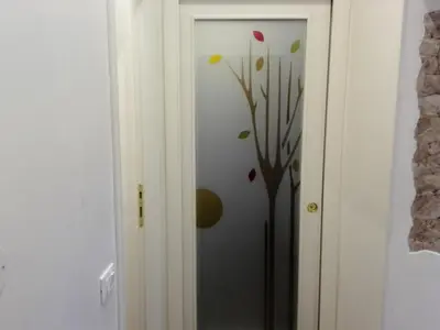 a door with a vase with a tree on it at Appartamento Cuore Antico in Rome