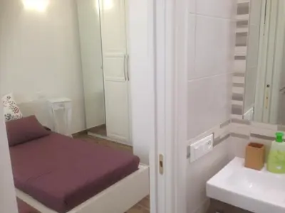 a small room with a bed and a sink at Appartamento Cuore Antico in Rome