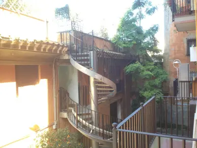 a building with a spiral staircase on the side of it at Appartamento Cuore Antico in Rome