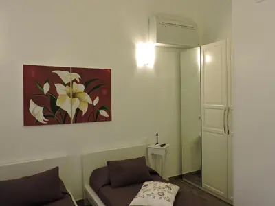 a living room with a couch and a painting on the wall at Appartamento Cuore Antico in Rome