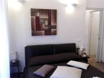 a couch in a living room with a painting on the wall at Appartamento Cuore Antico in Rome