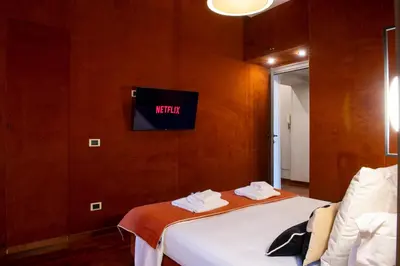 a room with a bed and a tv on the wall at Pantheon Deluxe in Rome