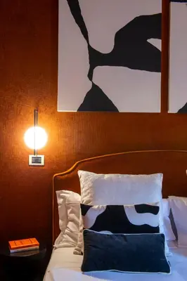 a bedroom with a bed and a painting on the wall at Pantheon Deluxe in Rome