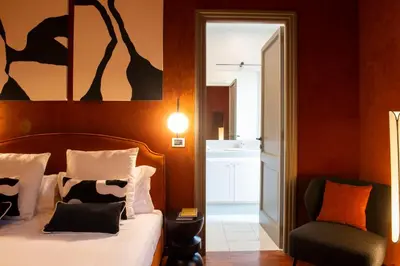 a bedroom with a bed and a chair at Pantheon Deluxe in Rome