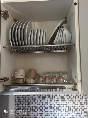 a kitchen with plates and bowls on a shelf at Rome center near Colosseum and metro a in Rome