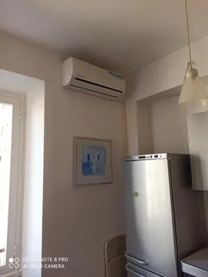 a kitchen with a refrigerator and a ceiling fan at Rome center near Colosseum and metro a in Rome
