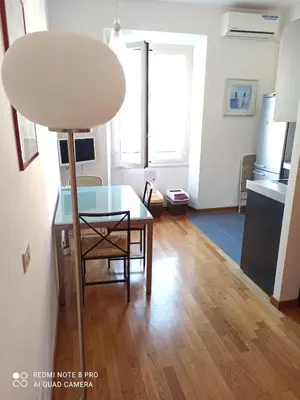 a living room with a table and a lamp at Rome center near Colosseum and metro a in Rome