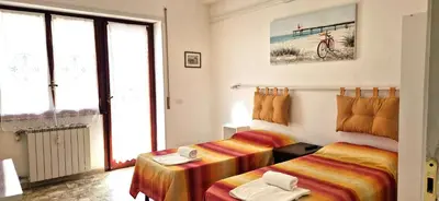 a hotel room with two beds and a window at Alloggio Turistico Perez Martinez Maria Petronila in Rome