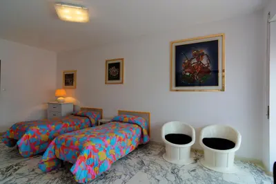 a bedroom with two beds and two white chairs at La Casetta Di Nonna Anna - 120 mq Bright Apartment in Rome in Rome
