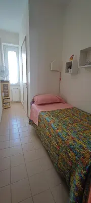 a bedroom with a bed and a tiled floor at La Casetta Di Nonna Anna - 120 mq Bright Apartment in Rome in Rome