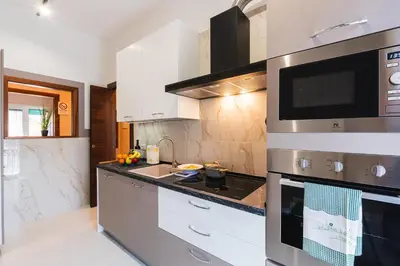 a kitchen with a sink and a stove top oven at Comfort House in Rome