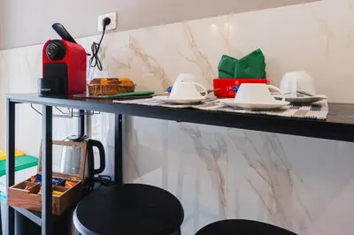 a counter with plates and dishes on a table at Comfort House in Rome