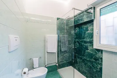 a bathroom with a shower and a toilet and a sink at Comfort House in Rome