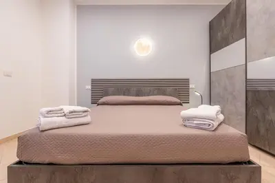 a bedroom with a large bed with towels on it at Comfort House in Rome