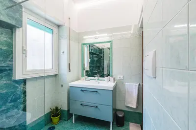 a bathroom with a sink and a glass shower at Comfort House in Rome