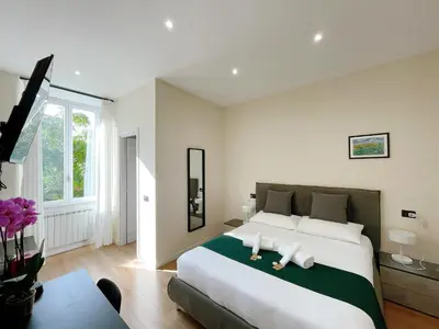 a bedroom with a large bed with two stuffed animals on it at Laterano's House in Rome