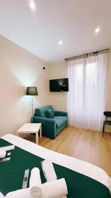 a hotel room with a bed and a couch at Laterano's House in Rome
